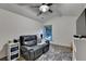 Comfortable bonus room featuring plush seating, a ceiling fan, and natural light at 127 Bradshaw Park Dr, Woodstock, GA 30188