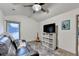 Inviting bonus room with a ceiling fan, comfortable seating, and entertainment options at 127 Bradshaw Park Dr, Woodstock, GA 30188