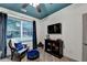 Well-lit home office with dark blue ceiling, large window, and stylish furnishings at 127 Bradshaw Park Dr, Woodstock, GA 30188