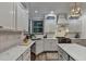 Bright kitchen with white cabinets, stainless steel appliances, and stone countertops at 127 Bradshaw Park Dr, Woodstock, GA 30188