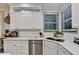 Bright kitchen with white cabinetry, updated appliances, and a double sink at 127 Bradshaw Park Dr, Woodstock, GA 30188