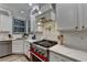 Updated kitchen with stainless appliances, mosaic backsplash, and stone countertops at 127 Bradshaw Park Dr, Woodstock, GA 30188