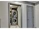 Convenient laundry area with stacked washer and dryer, and storage options at 127 Bradshaw Park Dr, Woodstock, GA 30188