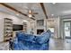 Bright living room boasts wood beam ceiling, fireplace, and sliding door to backyard at 127 Bradshaw Park Dr, Woodstock, GA 30188