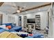 Open living room featuring wood beam ceilings, stylish decor, and gray vinyl flooring at 127 Bradshaw Park Dr, Woodstock, GA 30188