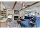 Cozy living room with fireplace, beamed ceiling, and comfortable blue sectional at 127 Bradshaw Park Dr, Woodstock, GA 30188
