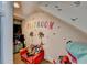 Attic playroom featuring colorful wall decor, hardwood floors, and furniture at 127 Bradshaw Park Dr, Woodstock, GA 30188
