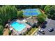 Community pool with ample lounge chairs, umbrellas, cabana, tennis courts, lush trees, and parking at 127 Bradshaw Park Dr, Woodstock, GA 30188