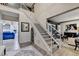 Elegant foyer with a grand staircase featuring white railings, hardwood floors, and a view into the living spaces at 127 Bradshaw Park Dr, Woodstock, GA 30188