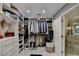Organized walk-in closet with custom shelving, drawers, and access to a well-appointed bathroom at 127 Bradshaw Park Dr, Woodstock, GA 30188
