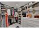 Well-organized walk-in closet featuring custom shelving and hanging racks for efficient storage and style at 127 Bradshaw Park Dr, Woodstock, GA 30188
