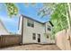 View of the backyard, wooden fence, with green tree foliage, and black trim exterior at 131 Turning Point, Stockbridge, GA 30281