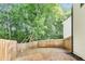 Fenced-in backyard featuring lush green trees on a bright day at 131 Turning Point, Stockbridge, GA 30281