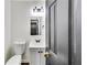 Well-lit half bathroom featuring a modern vanity with new light fixtures at 131 Turning Point, Stockbridge, GA 30281