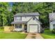 Charming two-story home featuring a well-manicured lawn, single car garage, and fresh landscaping at 131 Turning Point, Stockbridge, GA 30281