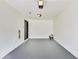 A standard garage with white painted walls and a gray floor at 131 Turning Point, Stockbridge, GA 30281