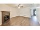 Living room showcasing a fireplace, wood-look flooring, neutral paint, and a ceiling fan at 131 Turning Point, Stockbridge, GA 30281