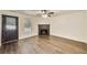 Living room showcasing a fireplace, wood-look flooring, neutral paint, and a window at 131 Turning Point, Stockbridge, GA 30281