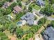 Stunning aerial view of a luxurious property with a large in-ground pool, manicured landscaping, and a circular driveway at 3090 Creek Tree Lane, Cumming, GA 30041