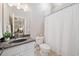 Functional bathroom complete with a single sink vanity, shower with curtain, and a neutral color palette at 3090 Creek Tree Lane, Cumming, GA 30041