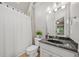 Well-maintained bathroom featuring a sleek vanity, tiled floor, and shower with curtain at 3090 Creek Tree Lane, Cumming, GA 30041