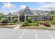 Traditional style clubhouse with stone accents, covered porch, manicured landscaping, and ample parking at 3090 Creek Tree Lane, Cumming, GA 30041