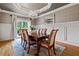 Dining room with a chandelier, wainscoting, wood floors, and access to the backyard at 3090 Creek Tree Lane, Cumming, GA 30041