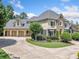 Beautiful home with an attached portico for multiple vehicles, tasteful landscaping, and attractive architectural details at 3090 Creek Tree Lane, Cumming, GA 30041