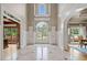Bright foyer features marble floors, high ceilings, and a view of the front yard through the glass paned doors at 3090 Creek Tree Lane, Cumming, GA 30041