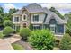 Elegant home with stone accents, lush landscaping, and a stately entrance, creating a grand curb appeal at 3090 Creek Tree Lane, Cumming, GA 30041