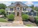 Stunning stone and stucco home with manicured landscaping, a welcoming entrance, and a beautiful stone walkway at 3090 Creek Tree Lane, Cumming, GA 30041