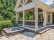Relaxing hot tub next to covered patio, surrounded by manicured landscaping and stone pavers at 3090 Creek Tree Lane, Cumming, GA 30041