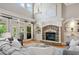 Living room featuring a stone fireplace, high ceilings, hardwood floors, and French doors at 3090 Creek Tree Lane, Cumming, GA 30041