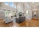 Spacious living room with stone fireplace, high ceilings, and French doors to outdoor area at 3090 Creek Tree Lane, Cumming, GA 30041