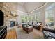 Cozy living room features a brick fireplace, natural light, and comfortable seating at 3090 Creek Tree Lane, Cumming, GA 30041