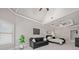 Spacious main bedroom featuring tray ceilings, seating area and stylish contemporary decor at 3090 Creek Tree Lane, Cumming, GA 30041