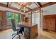 Home office with custom wood trim, hardwood floors, large windows, and a statement light fixture at 3090 Creek Tree Lane, Cumming, GA 30041