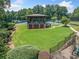 Community pavilion with a playground nearby, steps lead down to a grassy lawn and tennis courts at 3090 Creek Tree Lane, Cumming, GA 30041