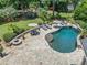 Inviting backyard pool area featuring a stone patio, fire pit, and lounge seating, perfect for outdoor relaxation and entertaining at 3090 Creek Tree Lane, Cumming, GA 30041