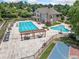 Aerial view of the community pool area featuring a large pool, pool, lounge chairs, pergola, and basketball court at 3090 Creek Tree Lane, Cumming, GA 30041