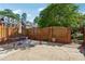 Brick patio area featuring a dining table, privacy fence and a brick retaining wall at 11715 Dancliff Trce, Alpharetta, GA 30009