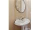 Bathroom featuring a pedestal sink with a framed mirror above at 11715 Dancliff Trce, Alpharetta, GA 30009