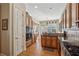 Spacious kitchen featuring custom cabinetry, granite countertops, and modern appliances, open to the dining area at 11715 Dancliff Trce, Alpharetta, GA 30009