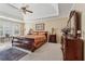 A main bedroom with a ceiling fan, large windows, and neutral walls offers a relaxing space at 11715 Dancliff Trce, Alpharetta, GA 30009