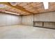 Spacious unfinished basement with concrete floor and walls, open ceiling with insulation, and workbench at 257 Martin Ln, Canton, GA 30114