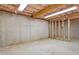 Unfinished basement with concrete floor and walls, and exposed ceiling with insulation and framing at 257 Martin Ln, Canton, GA 30114