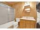 Bright bathroom features shower-tub combo, modern vanity, and matching toilet next to a stacked washer/dryer at 257 Martin Ln, Canton, GA 30114