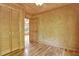 Bedroom with hardwood floors featuring natural wood walls, closet, and doorway leading to another room at 257 Martin Ln, Canton, GA 30114