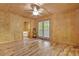 Bedroom with hardwood floors, natural wood walls and a glass-door entry to a balcony overlooking wooded backyard at 257 Martin Ln, Canton, GA 30114
