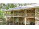 Two-story home featuring stone siding and a large porch, surrounded by lush trees at 257 Martin Ln, Canton, GA 30114